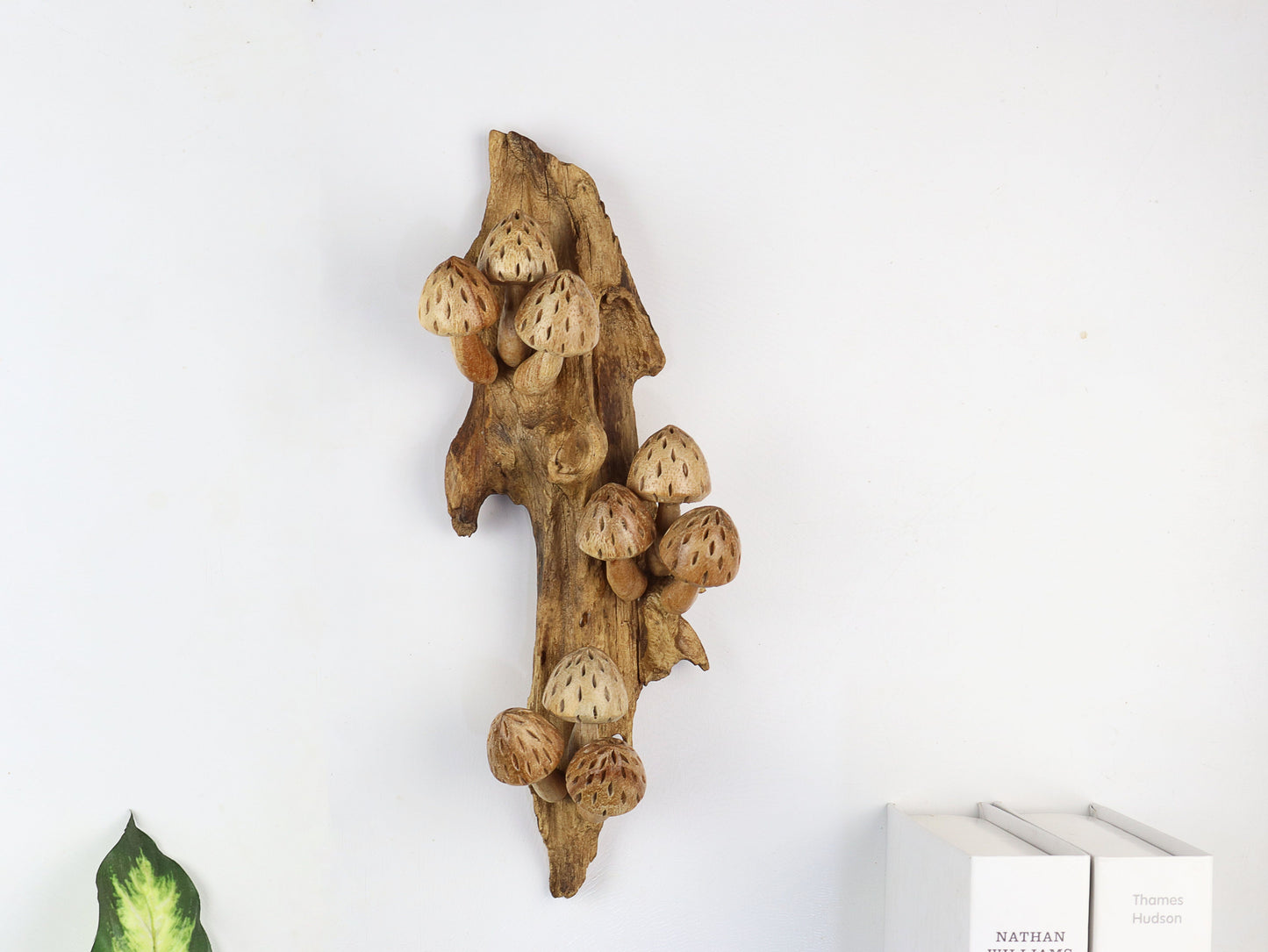 Vertical hand-carved natural wooden sculpture featuring multiple conical mushrooms with textured caps fanning out along an upright wood log or root, rustic wall art decor.
