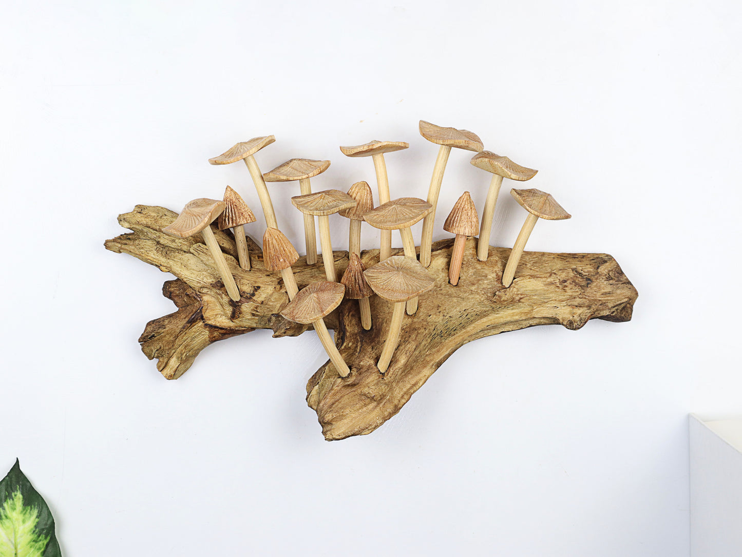 Large hand-carved natural wooden sculpture featuring multiple detailed mushrooms growing horizontally on a wide, textured wood log or root, rustic woodland decor.