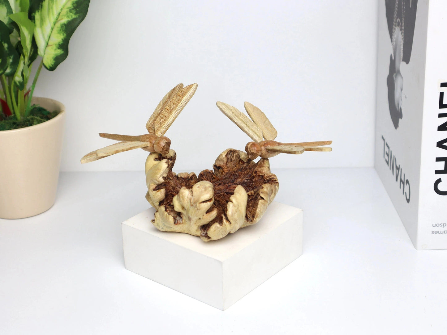 Hand-carved natural wooden sculpture featuring a pair of dragonflies facing each other on a gnarled horizontal wood piece, rustic tabletop decor.