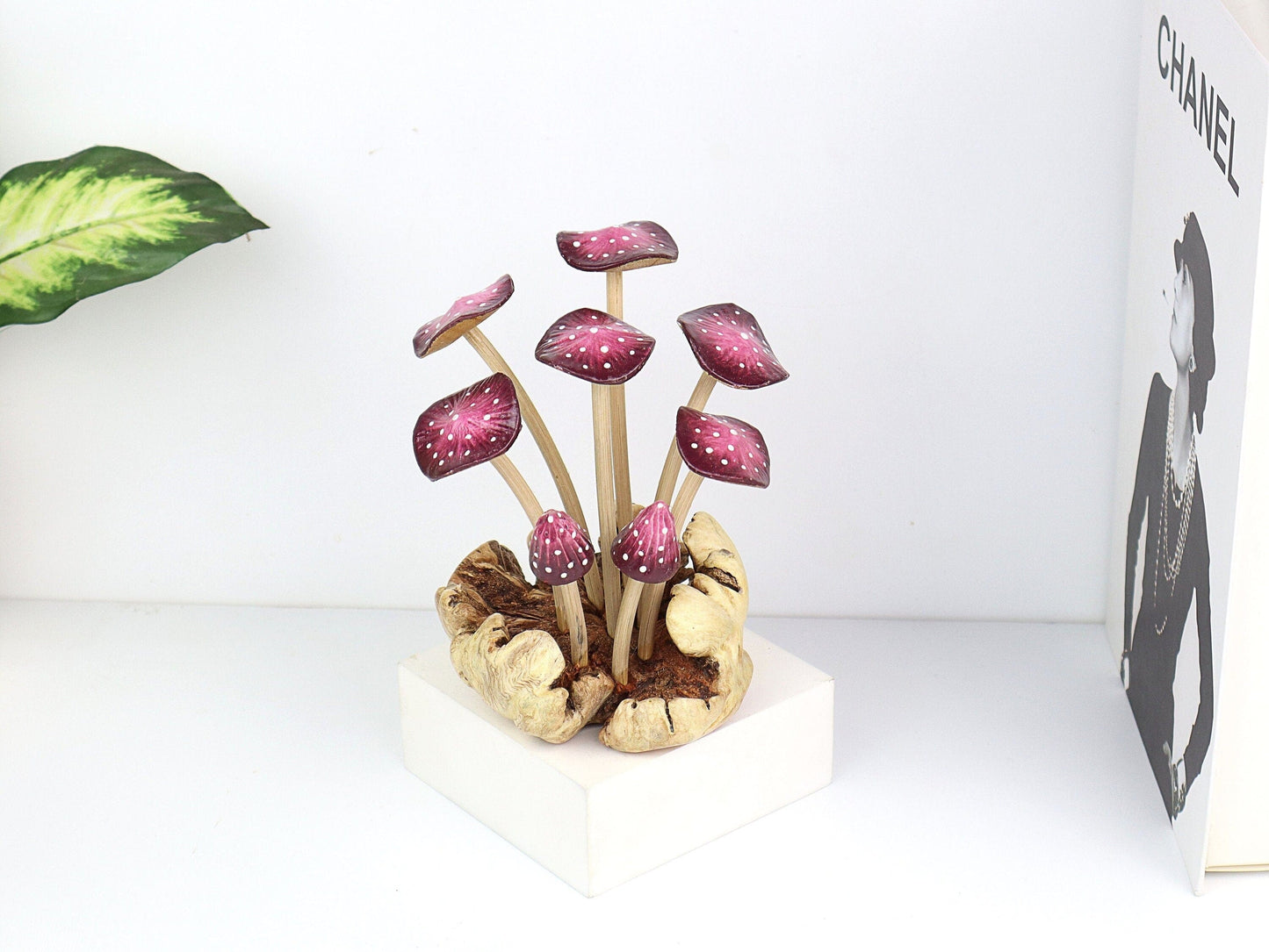 Hand-carved wooden mushroom sculpture with a cluster of seven purple fanned caps with white polka dots on a rustic wood base, whimsical tabletop decor.