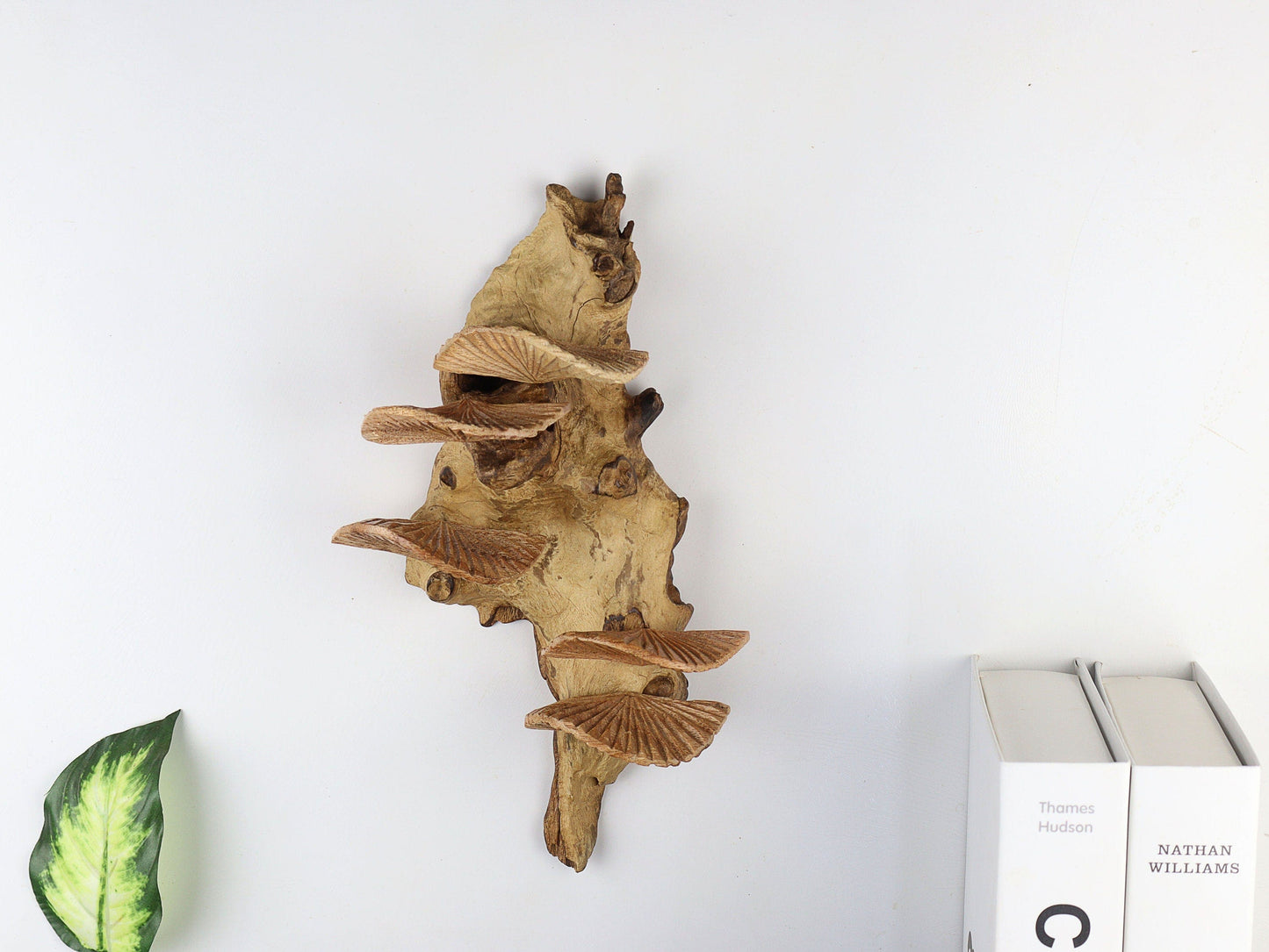 Hand-carved natural wooden sculpture featuring multiple fanned or shelf-like mushrooms growing vertically from a textured wood log or root, rustic wall art decor.