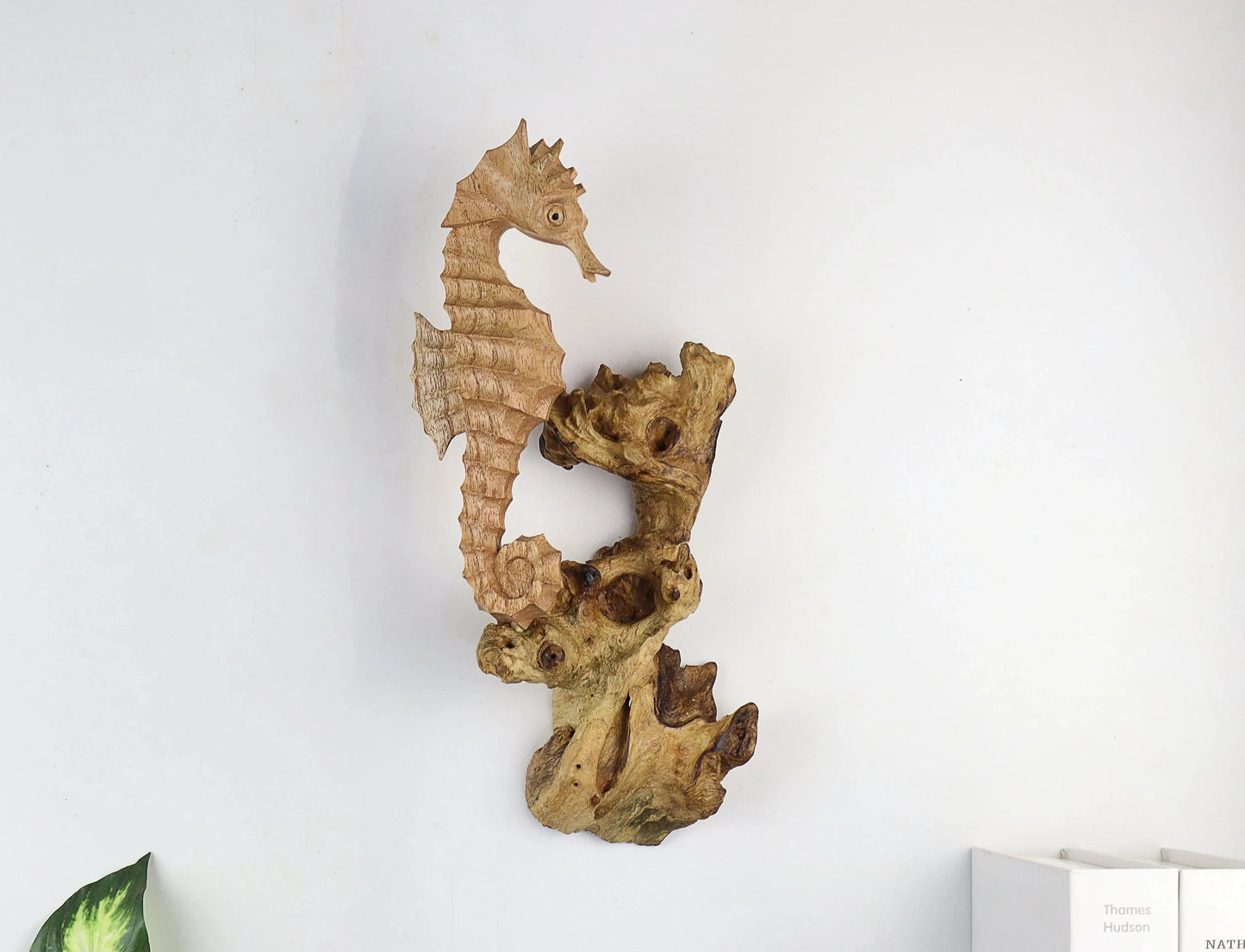 Hand-carved natural wooden wall art featuring a single seahorse on a rugged driftwood base, rustic coastal decor.