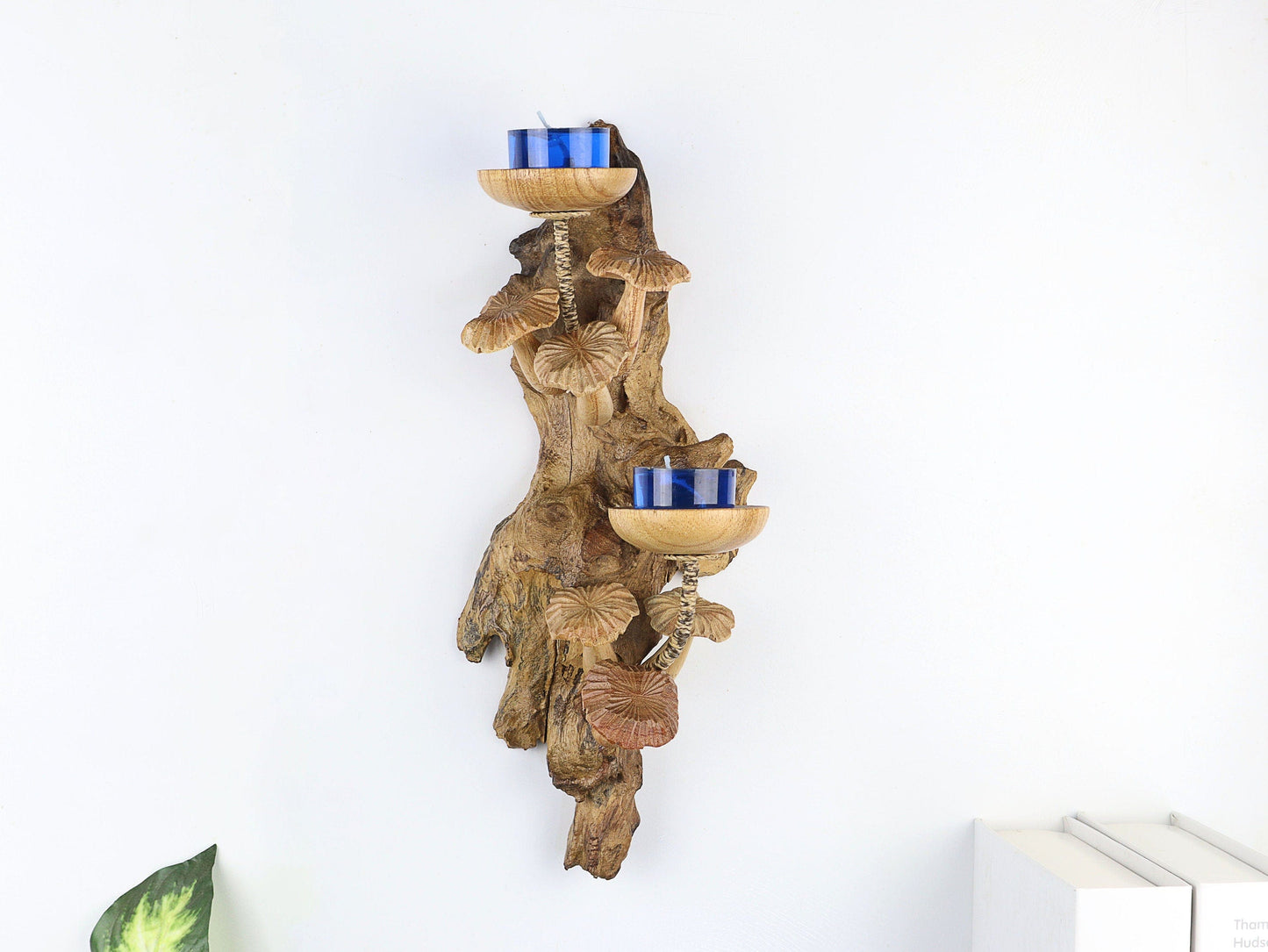 Hand-carved natural wooden wall sconce featuring a cluster of fanned mushrooms and two candle holders with blue tealights, rustic nature decor.