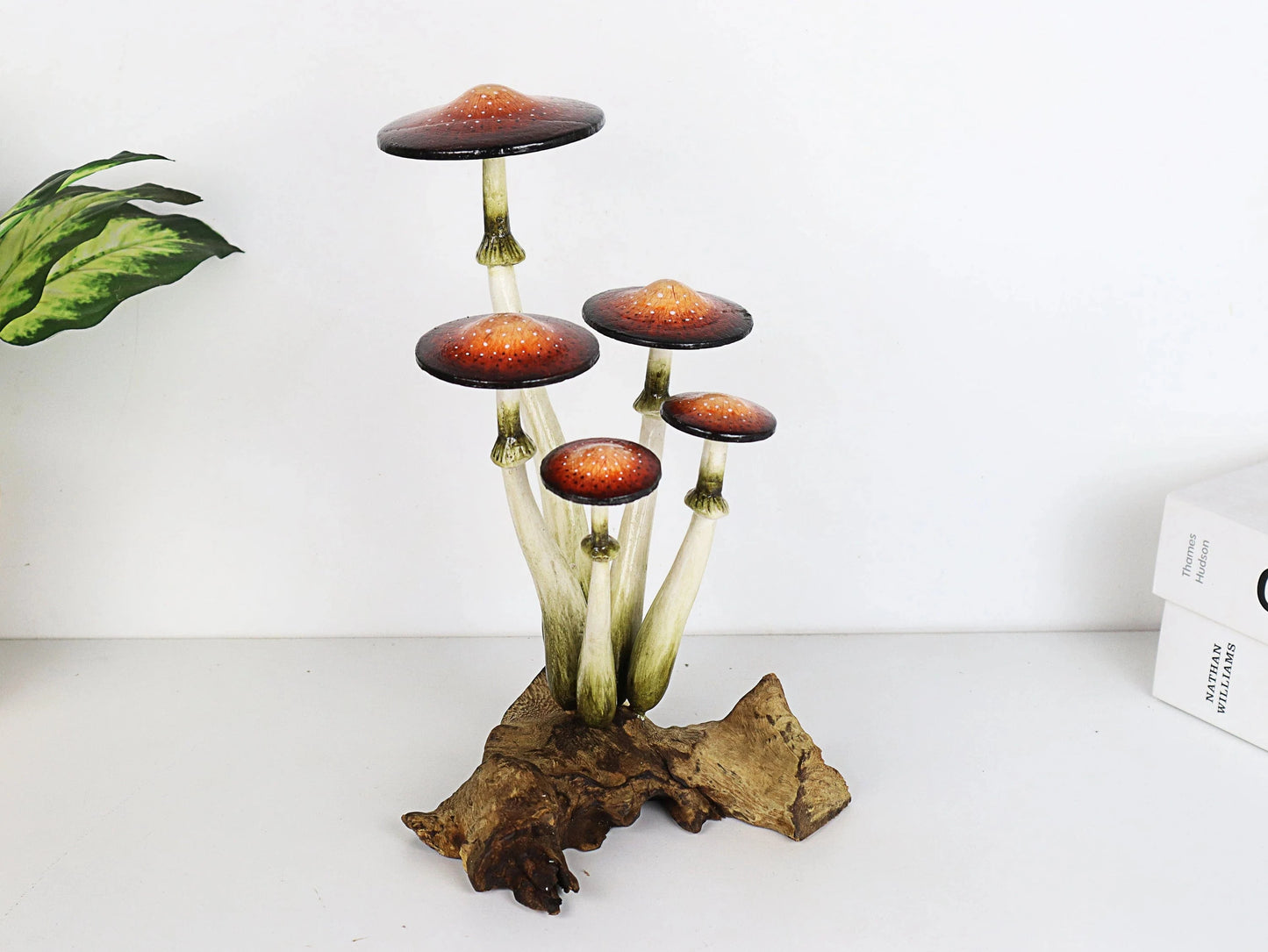 Hand-carved wooden mushroom sculpture with a cluster of five realistically painted brown-orange caps on a gnarled wood base, tabletop decor.