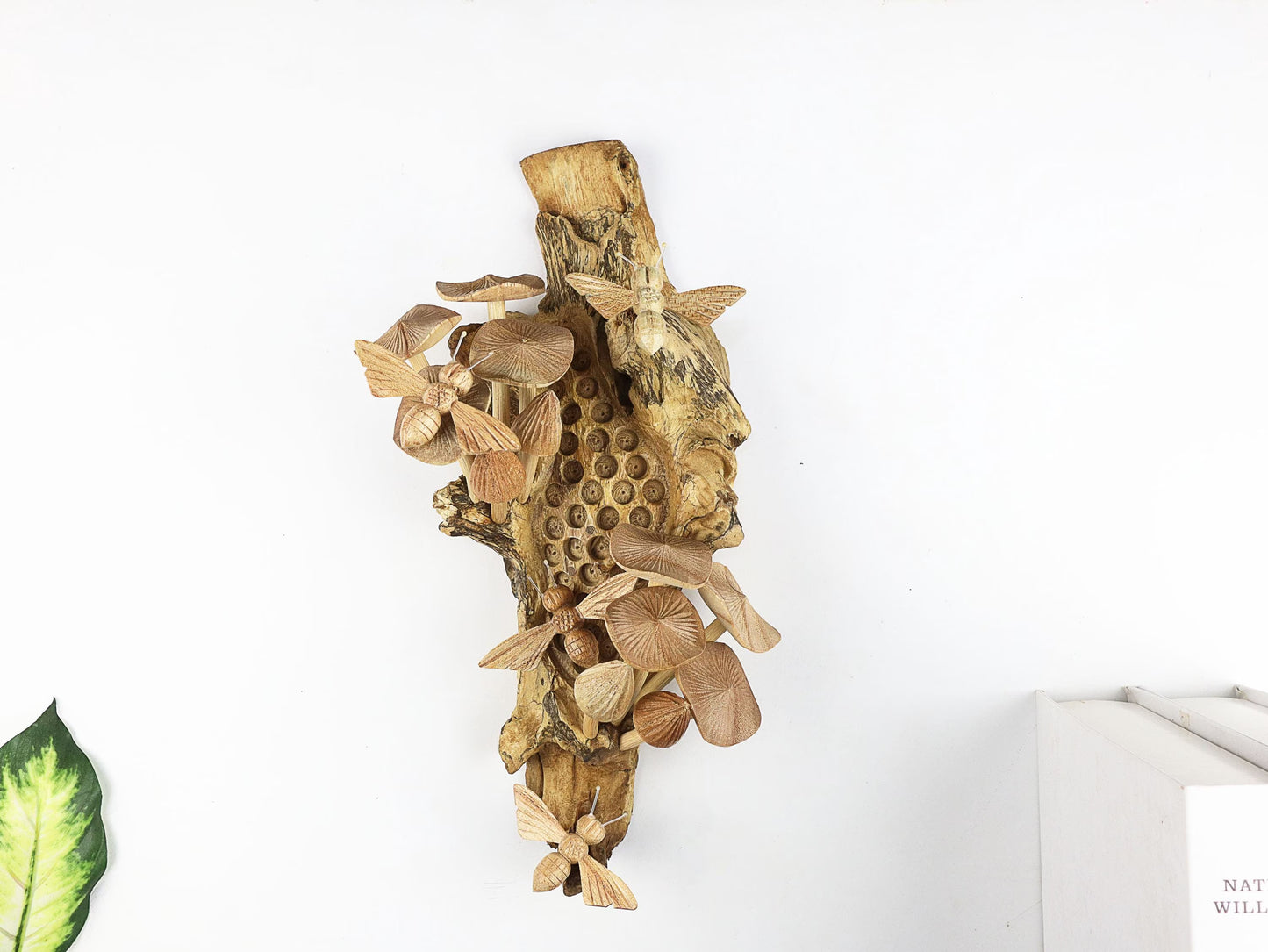 Hand-carved natural wooden wall art featuring bees and mushrooms on a carved honeycomb-like pattern on a gnarled upright wood log, rustic bee and fungus decor.