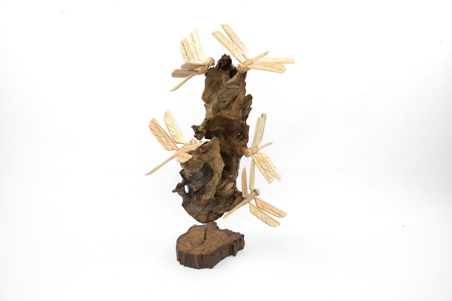 Hand-carved natural wooden sculpture featuring a cluster of multiple dragonflies on a gnarled upright wood piece, supported by a metal rod and a freestanding wooden base, rustic nature decor.