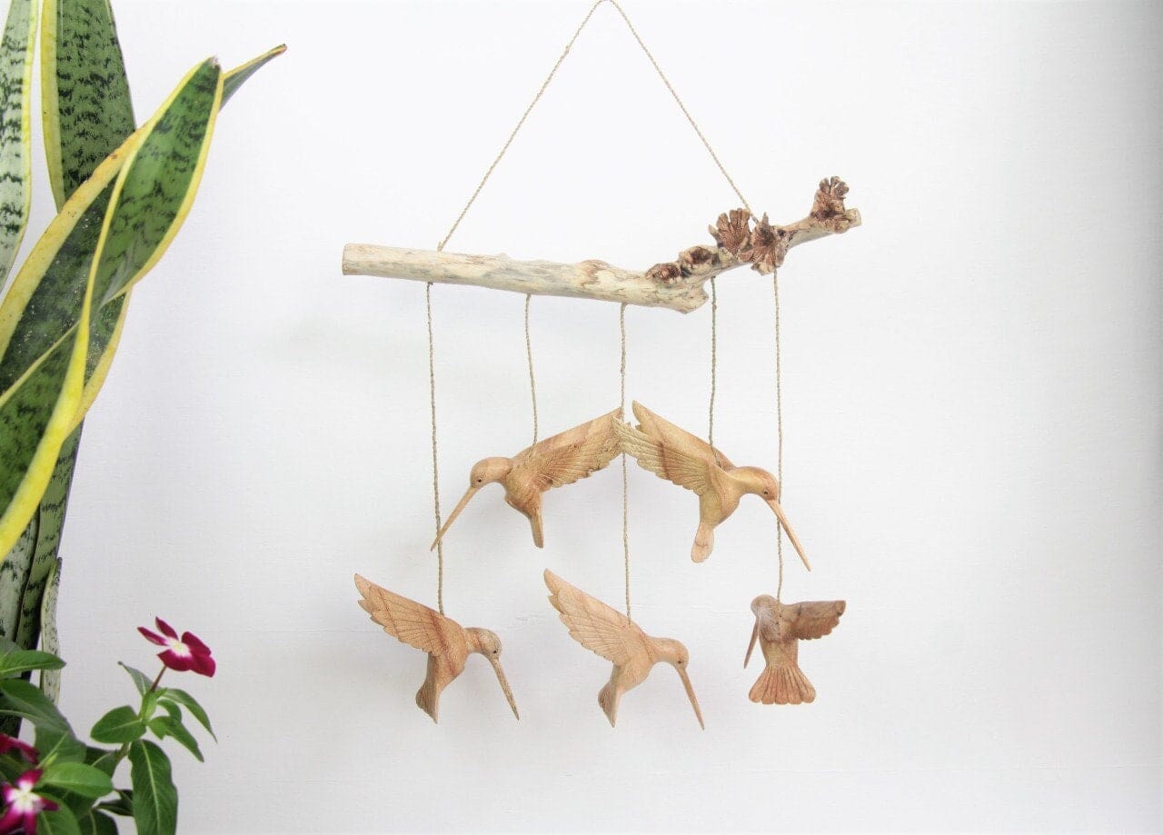 Hand-carved natural wooden mobile featuring five hummingbirds suspended by twine from a wooden branch, rustic hanging decor.