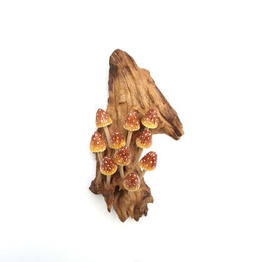 Hand-carved natural wooden sculpture featuring a large cluster of yellow, orange, and red polka-dot conical mushrooms on an upright natural wood log or root, whimsical wall art decor.