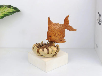 Hand-carved natural wooden sculpture featuring a fish rising from a textured, organic wood base, rustic coastal decor.