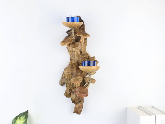 Hand-carved natural wooden wall sconce featuring a cluster of fanned mushrooms and two candle holders with blue tealights, rustic nature decor.