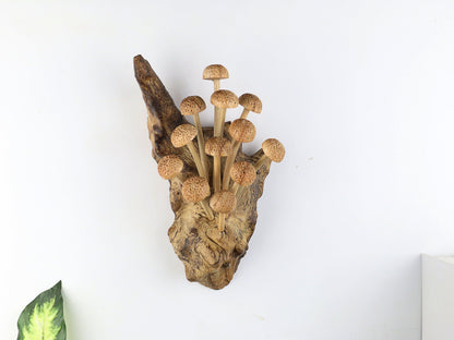 Hand-carved natural wooden sculpture featuring a dense cluster of textured bell-shaped mushrooms sprouting vertically from a gnarled wood log or root, rustic wall art decor.