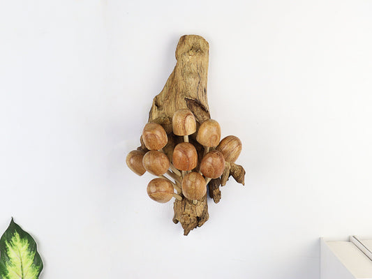 Hand-carved natural wooden sculpture featuring a dense cluster of rounded-cap mushrooms sprouting vertically from a textured wood log or root, rustic wall art decor.