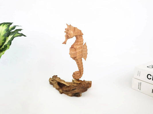 Hand-carved natural wooden sculpture featuring a single seahorse on a rugged driftwood base, rustic coastal decor.